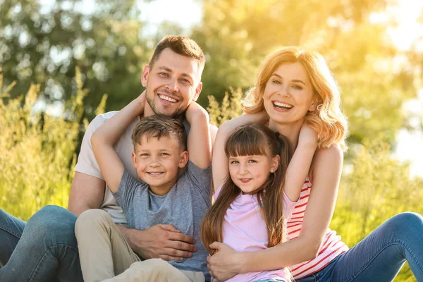 Happy family in park on summer day — Stock Photo, Image