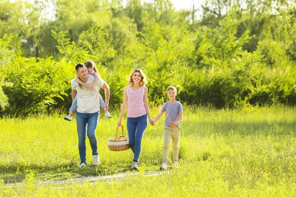 Happy family walking in park on summer day — Stock Photo, Image