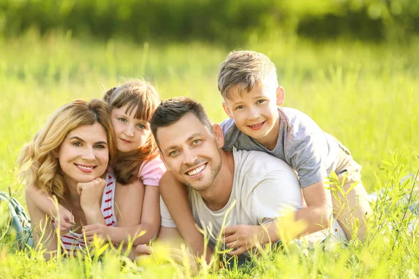 Happy family in park on summer day — Stock Photo, Image
