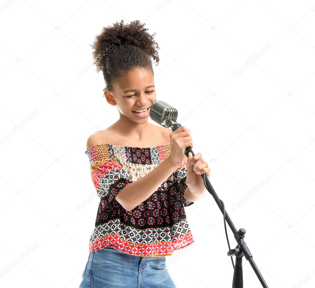 African-American girl with microphone singing against white background