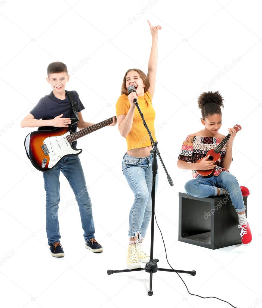 Teenage musicians playing against white background