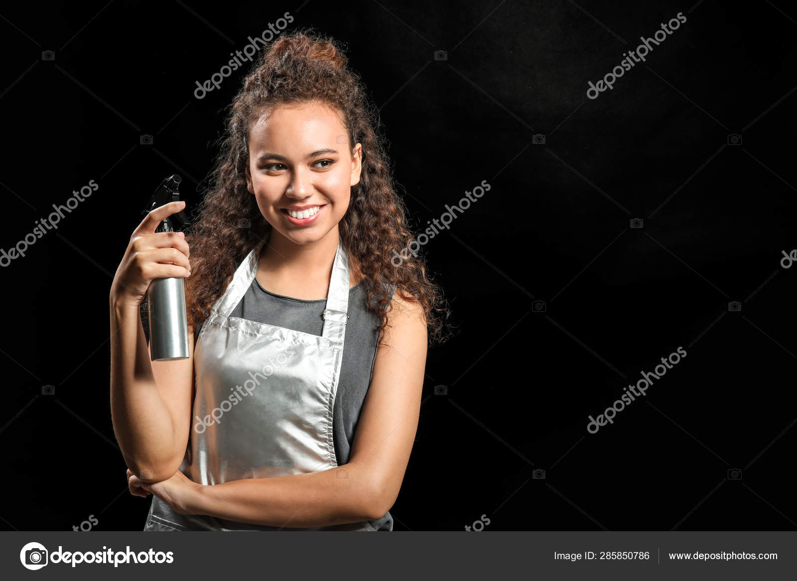 Beautiful African American Hairdresser On Dark Background Stock