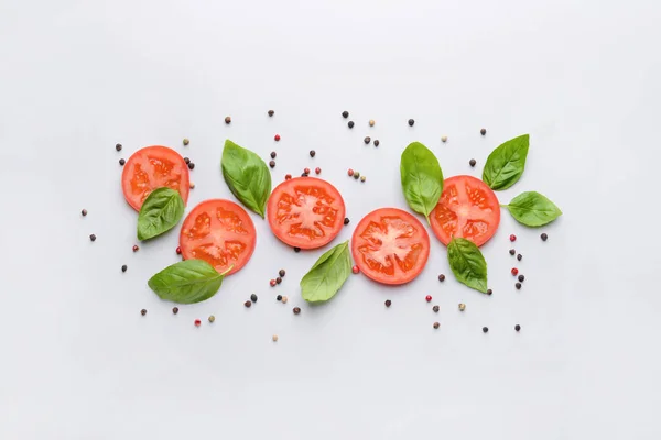 Fresh basil, tomato and spices on light background — Stock Photo, Image