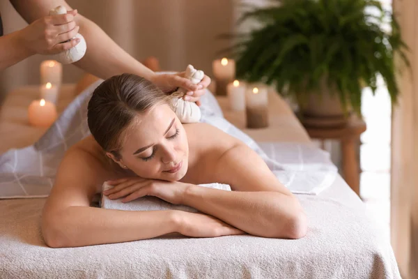 Beautiful young woman receiving massage in spa salon — Stock Photo, Image