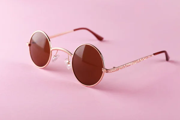 Stylish sunglasses on color background — Stock Photo, Image
