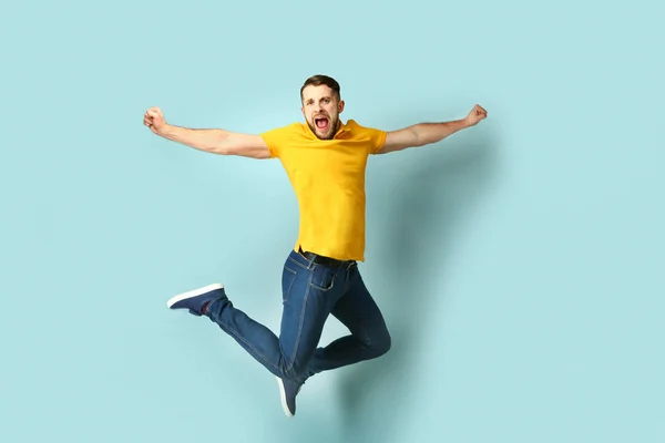 Sikoltozó jumping ember színes háttér — Stock Fotó