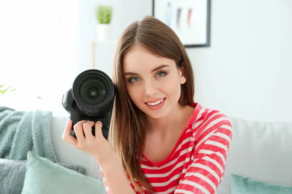 Young female photographer at home — Stock Photo, Image