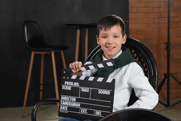 Little film director with clapperboard in studio — Stock Photo, Image