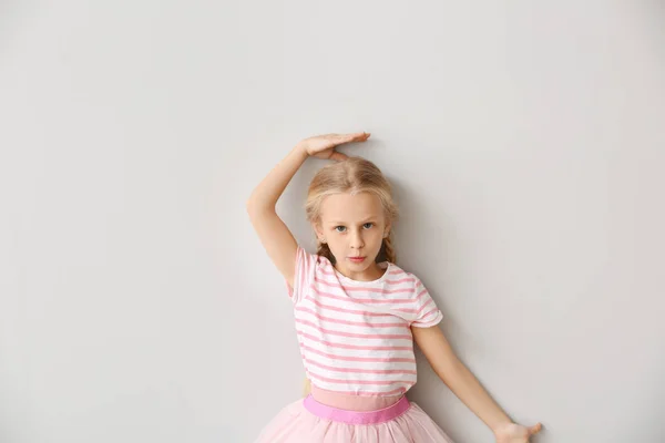 Cute little girl measuring height near wall — Stock Photo, Image