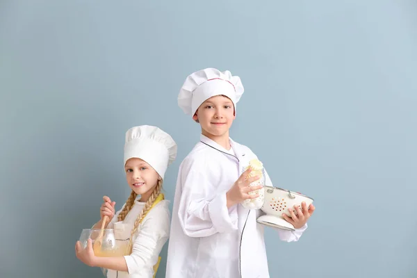 Cute little chefs on color background — Stock Photo, Image