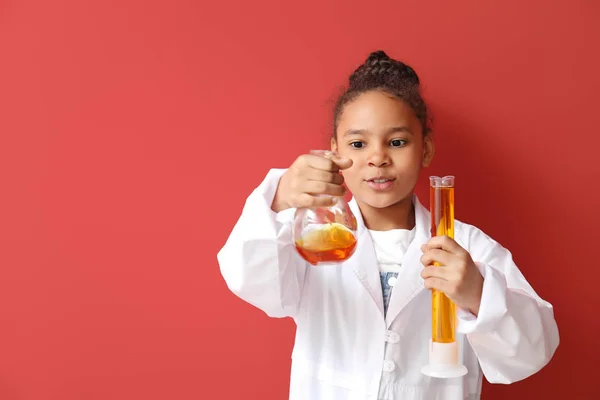 Little African-American scientist on color background — Stock Photo, Image