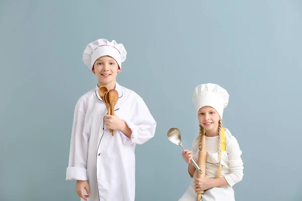 Cute little chefs on color background — Stock Photo, Image