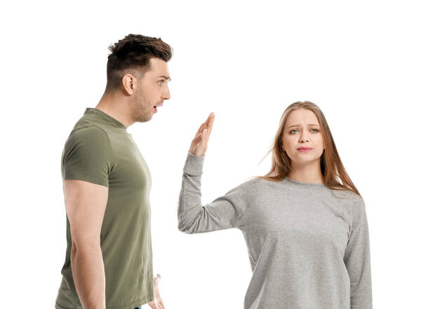 Young quarrelling couple on white background