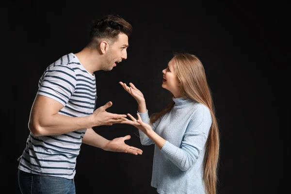 Jovem casal brigando no fundo escuro — Fotografia de Stock