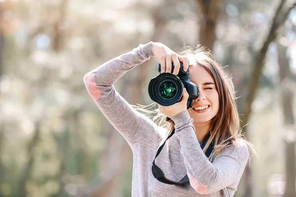 Beautiful female photographer working outdoors — Stock Photo, Image