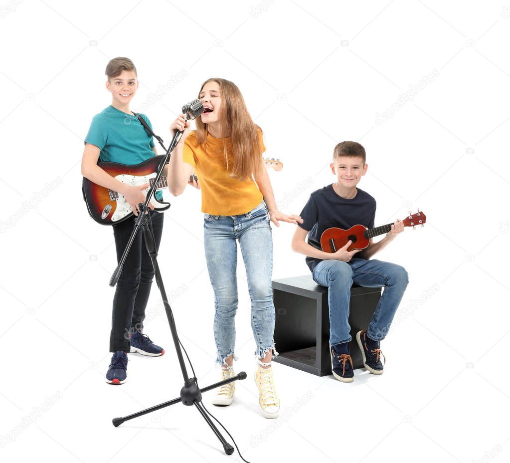 Teenage musicians playing against white background