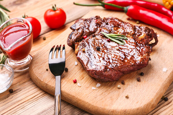 Tasty grilled meat on wooden board