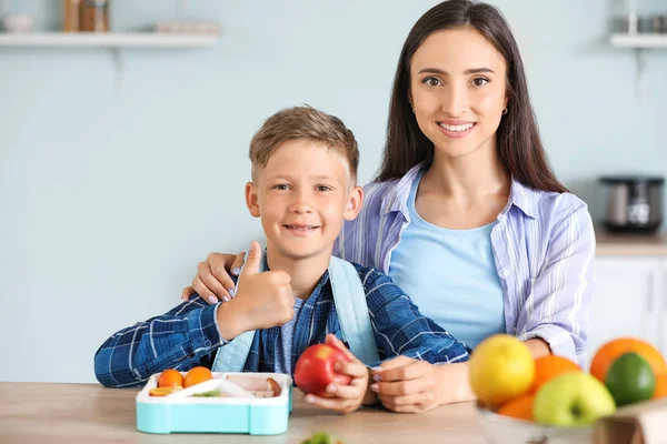 Mother and her little son with lunch box before school — Stock Photo, Image