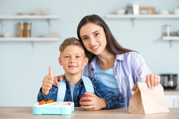 Mother and her little son with lunch box before school — Stock Photo, Image