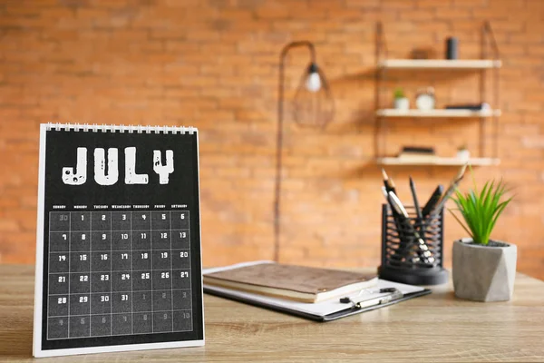 Flip paper calendar and stationery on office table — Stock Photo, Image