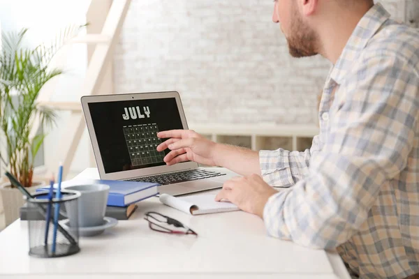 Man använder kalender på laptop skärm när du arbetar i Office — Stockfoto