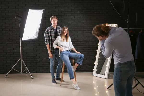 Fotógrafo profissional trabalhando com modelos em estúdio — Fotografia de Stock