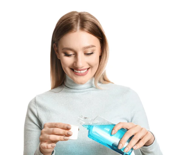 Woman with mouth rinse on white background