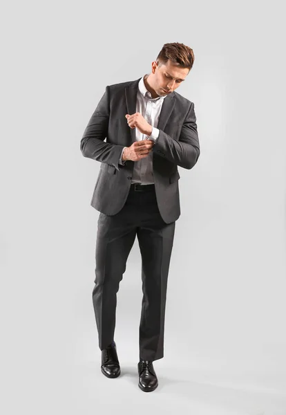 Fashionable young man on grey background — Stock Photo, Image