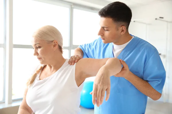 Physiotherapeutin arbeitet mit erwachsenen Patienten im Reha-Zentrum — Stockfoto