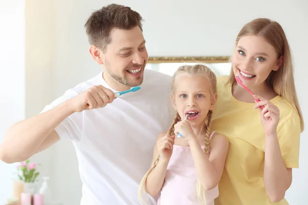 Family cleaning teeth at home