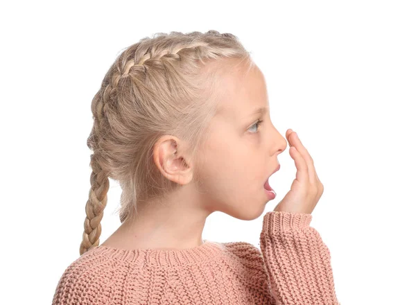 Klein meisje controleert de frisheid van haar adem op witte achtergrond — Stockfoto