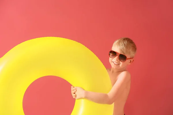 Cute little boy with inflatable ring on color background — Stock Photo, Image