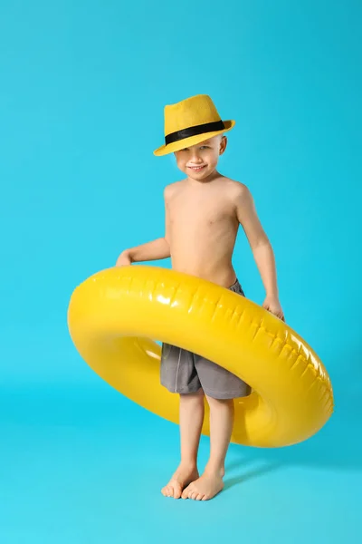 Cute little boy with inflatable ring on color background — Stock Photo, Image