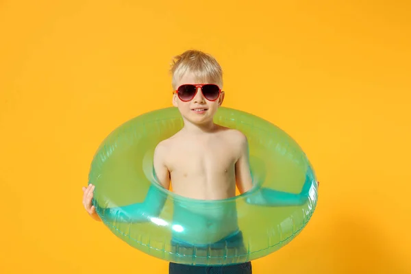 Mignon petit garçon avec anneau gonflable sur fond de couleur — Photo