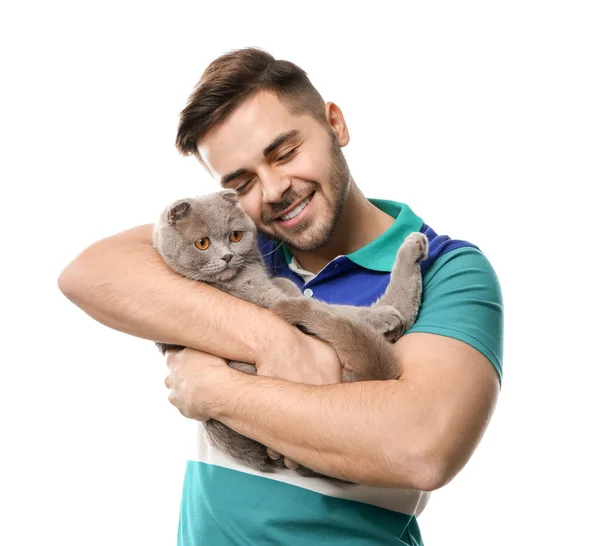 Young man with cute funny cat on white background — Stock Photo, Image