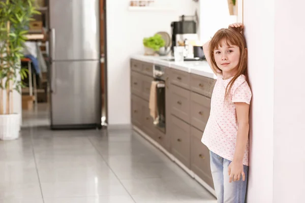 Little girl measuring height near wall — Stock Photo, Image