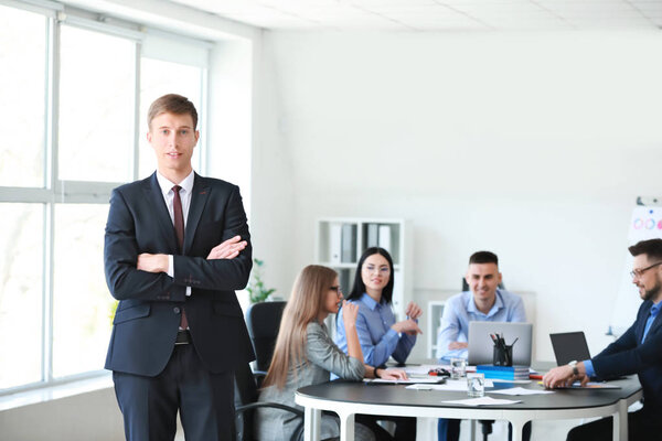 Businessman with colleagues during meeting in office