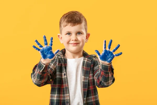 Funny little boy with hands in paint on color background — Stock Photo, Image