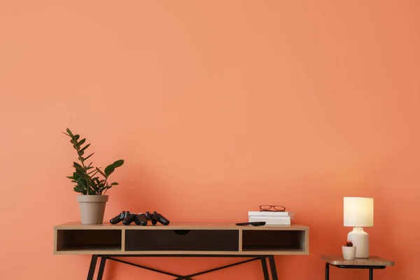 Modern table near color wall — Stock Photo, Image