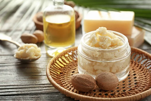 Jar with shea butter on wooden background — Stock Photo, Image