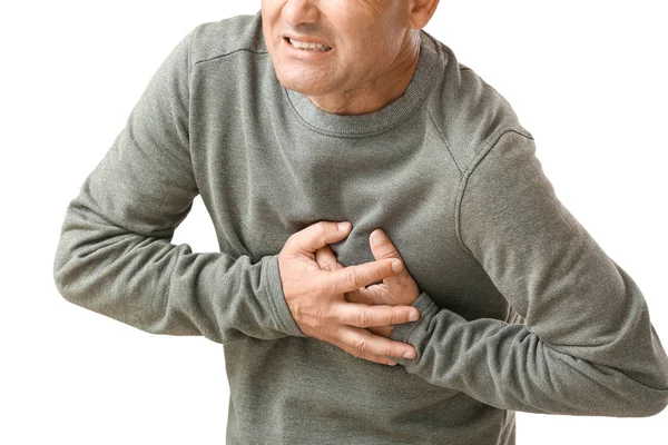 Mature man suffering from heart attack on white background — Stock Photo, Image