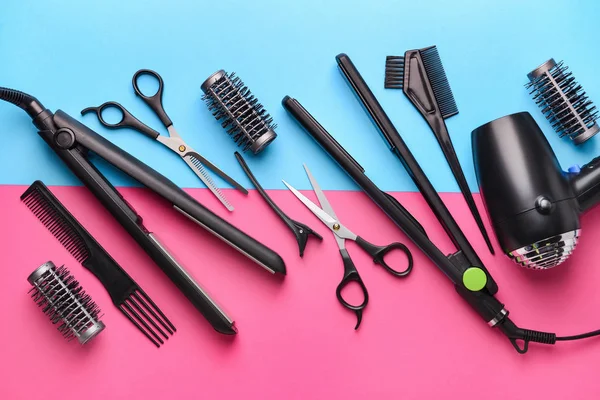 Set of hairdresser tools and accessories on color background