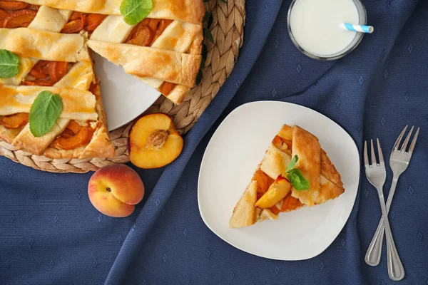 Composition with tasty peach pie on table