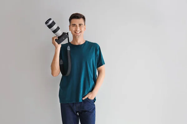 Male photographer on light background — Stock Photo, Image