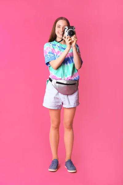 Teenage girl with photo camera on color background — Stock Photo, Image