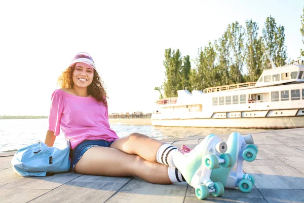 Beautiful young woman on roller skates outdoors — Stock Photo, Image