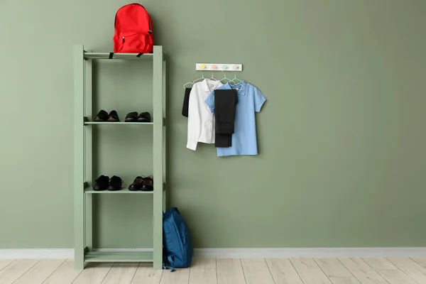 Stylish school uniform, backpack and shoes in room — Stock Photo, Image