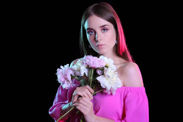 Fashionable young woman with flowers on dark background — Stock Photo, Image