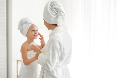 Anne uygulama krem üzerine yüz bu onu küçük kızı içinde banyo