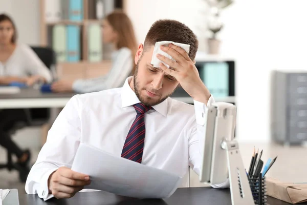 Businessman having panic attack in office